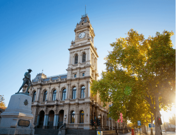 Historic building with clock tower and statue