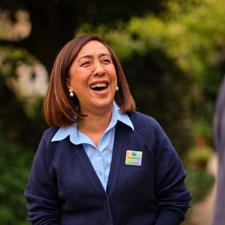 Smiling woman in a blue shirt and navy cardigan