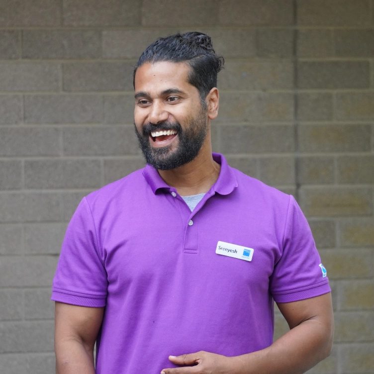 Smiling man in a purple polo shirt