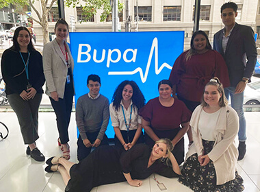 Group photo in front of Bupa office display