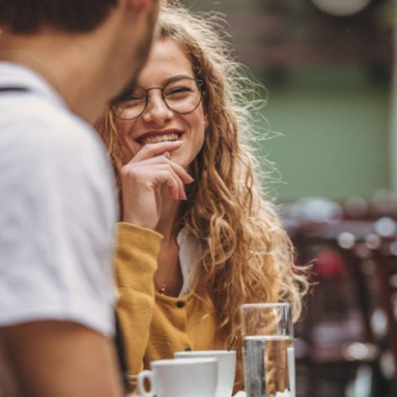 Two people chatting over coffee at cafe