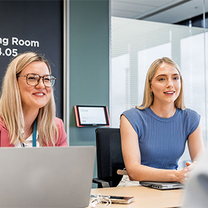 Professionals discussing work over laptop