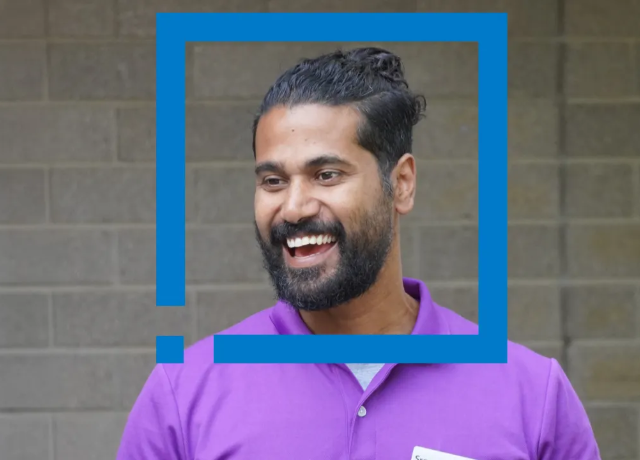 Smiling person in purple shirt