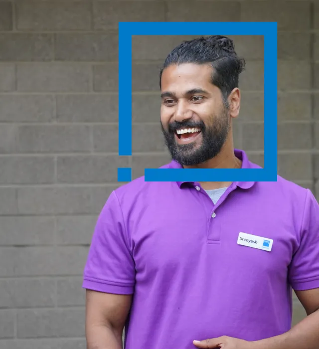 Smiling person in purple shirt