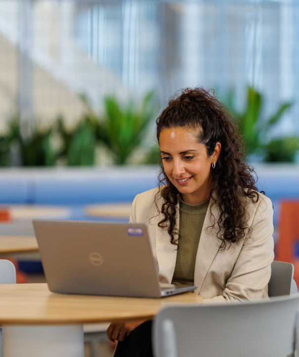 Professionals discussing work over laptop