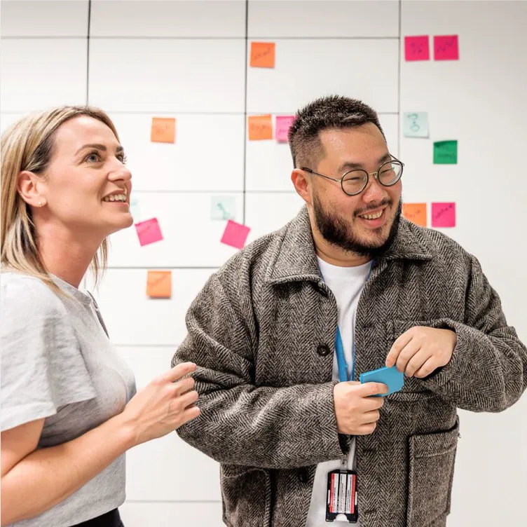 Colleagues collaborating with sticky notes