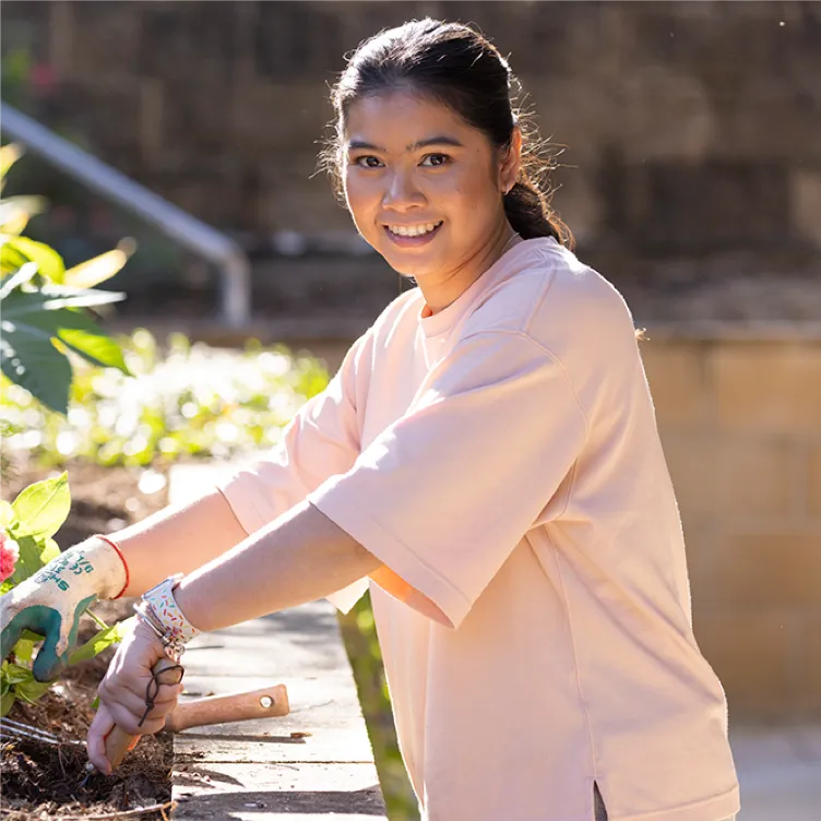 Person gardening in outdoor planter