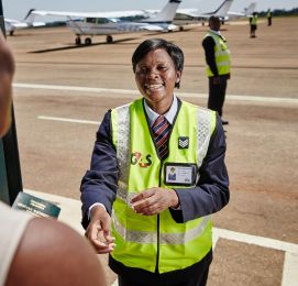 Airport security in bright vest standing on runway.