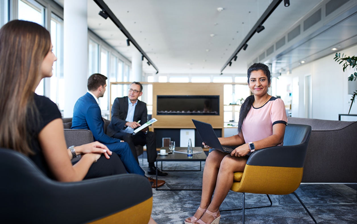 Woman with laptop in office lounge