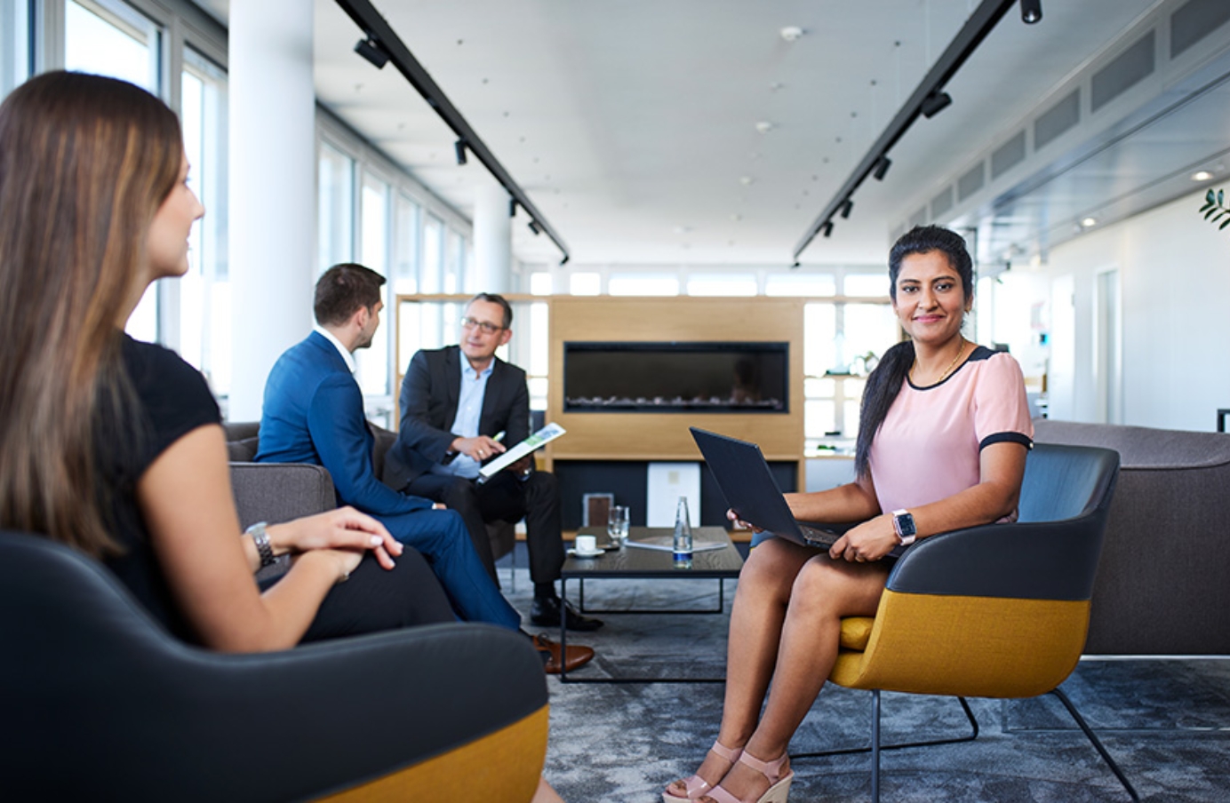 Woman with laptop in office lounge