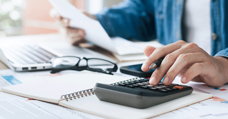 Calculating finances at desk