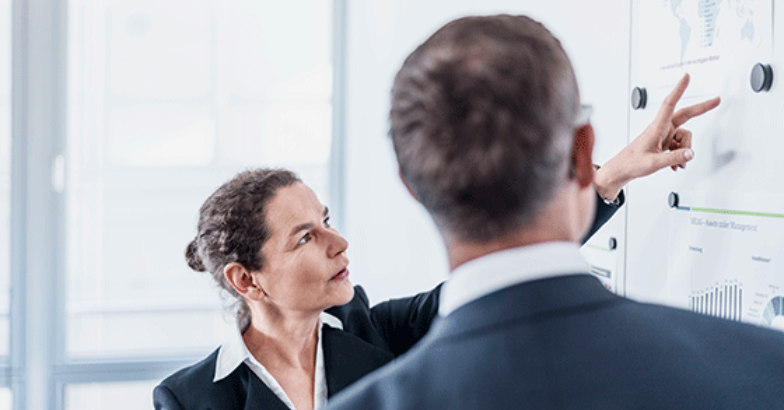 Colleagues reviewing control panel