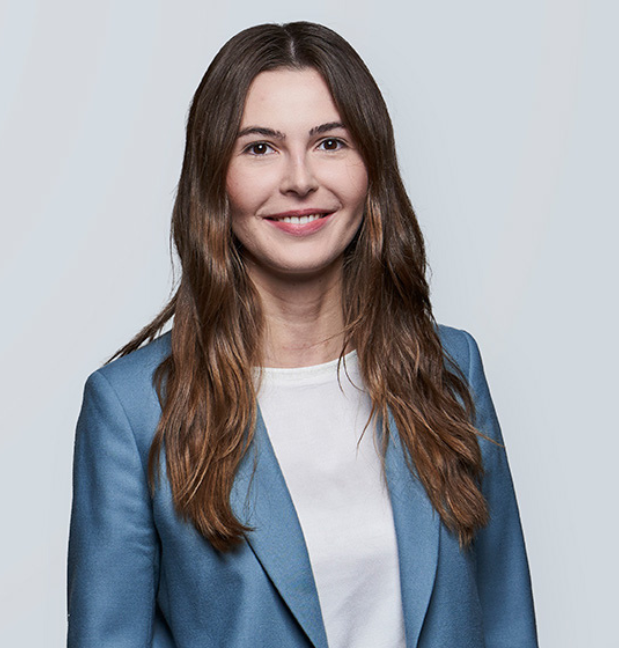 Person in light blue blazer and white top