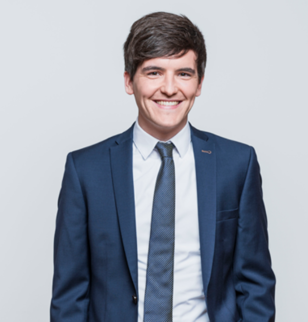 Person in dark blue suit and tie