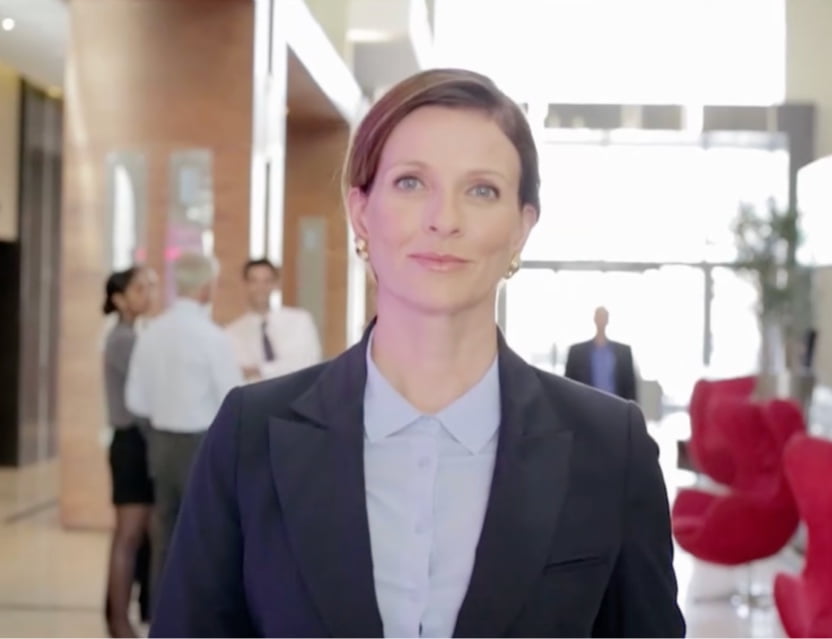 A woman standing in an office lobby