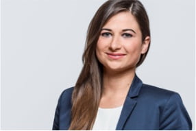A woman in a business suit smiling
