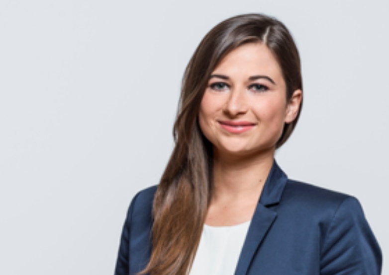 A woman in a business suit smiling