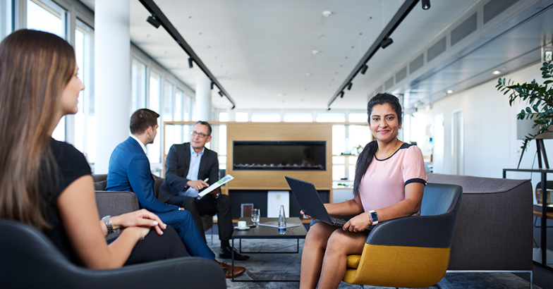 Woman with laptop in office lounge
