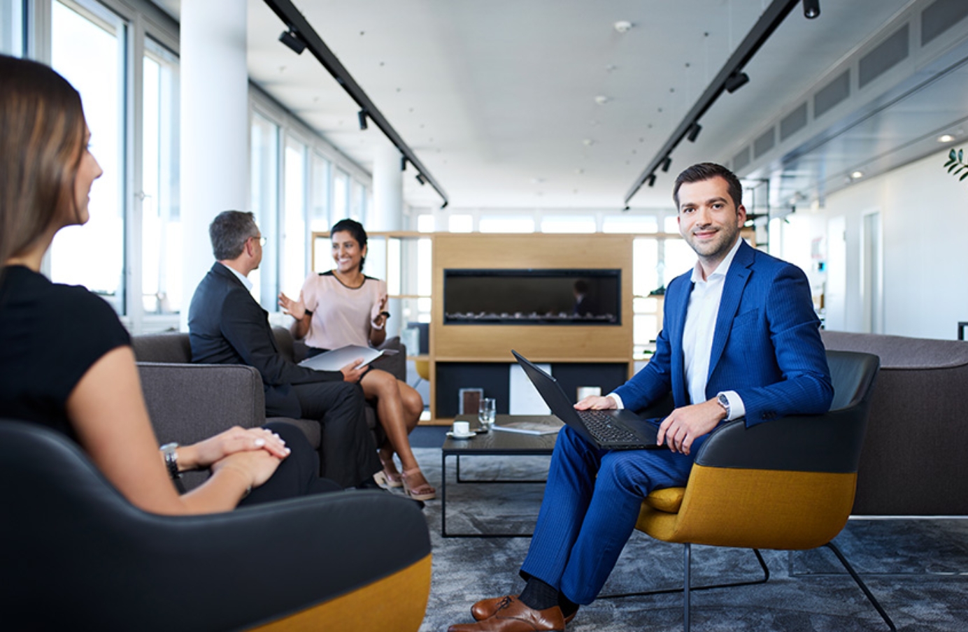 Man in suit working on laptop in office