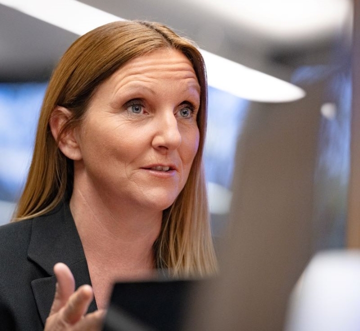 Woman talks during meeting in office room.
