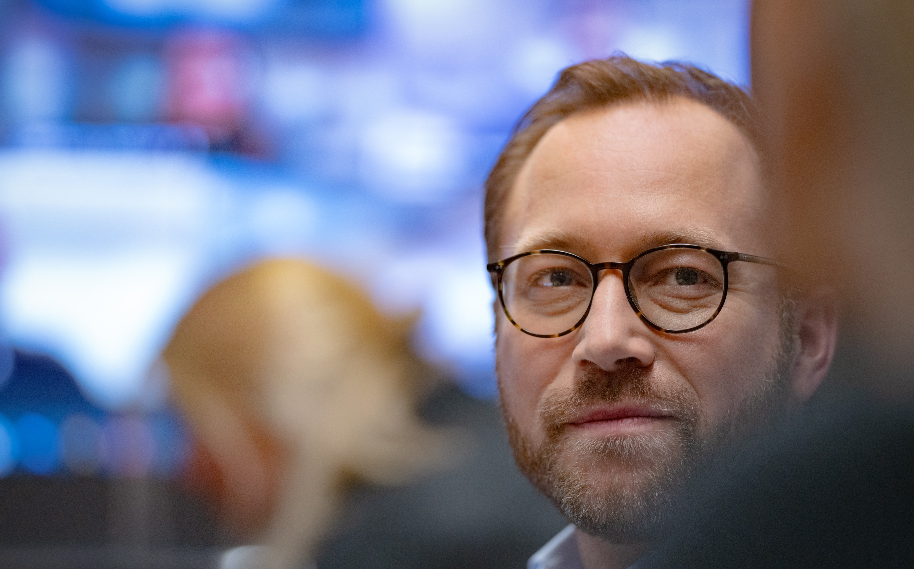 Man with glasses looking into the camera