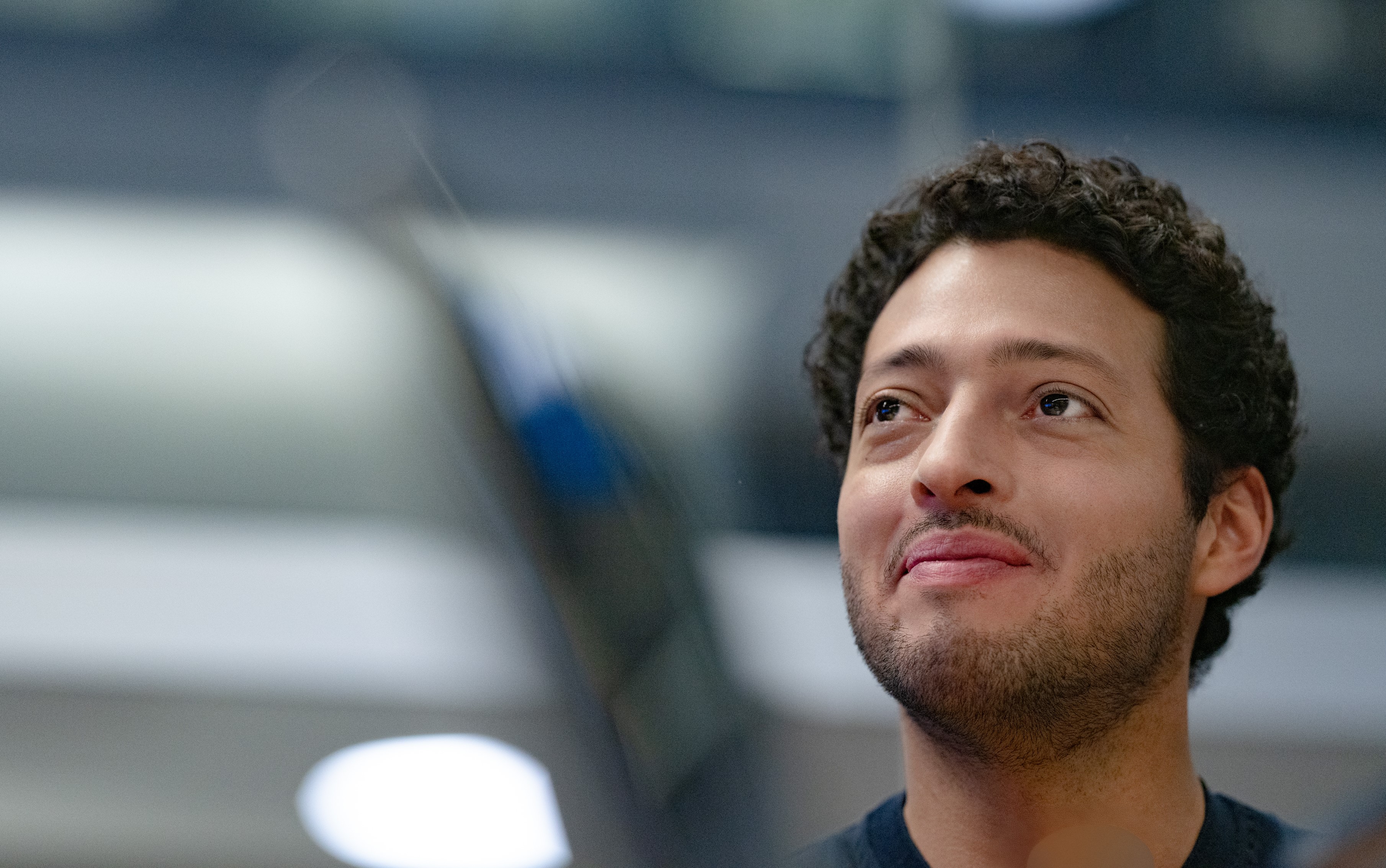 Friendly, almost smiling face of a young man not looking into the camera.