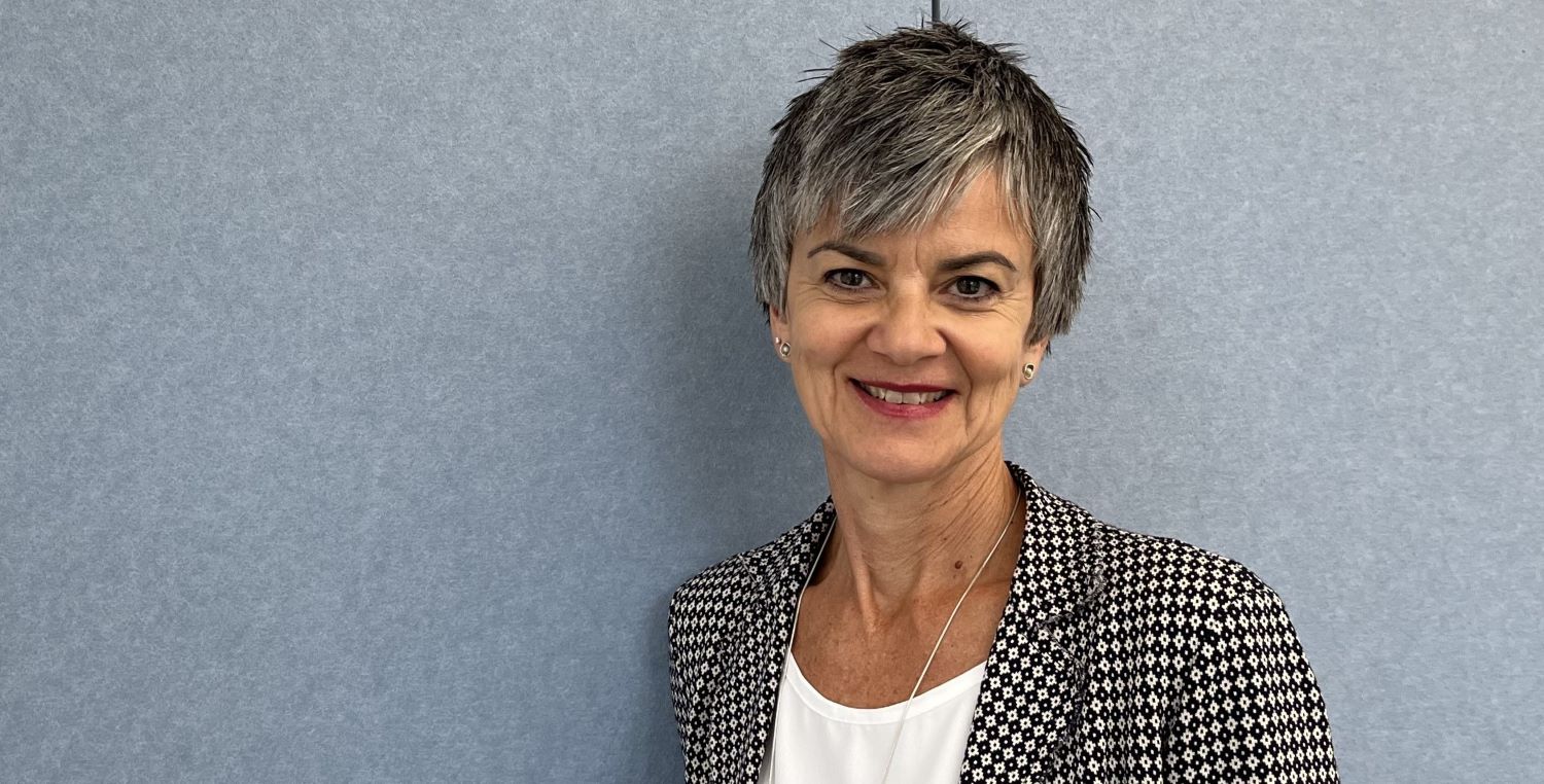 Woman smiling into the camera.