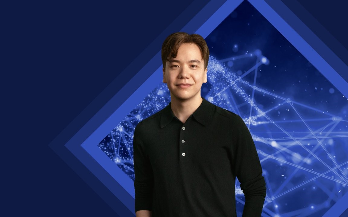 Freindly smiling young man in front of a technical background