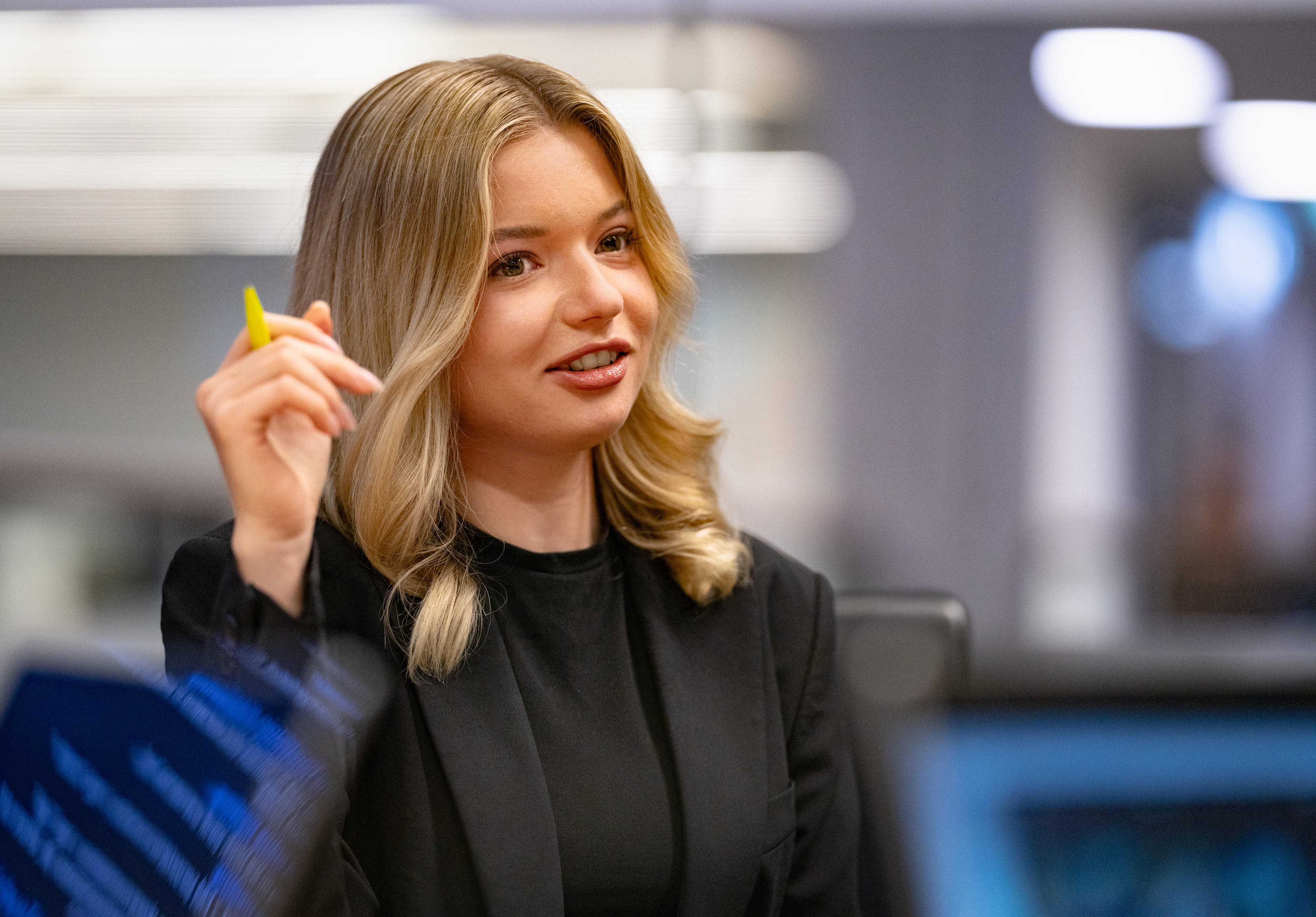 Young woman holding a pencil in her hand
