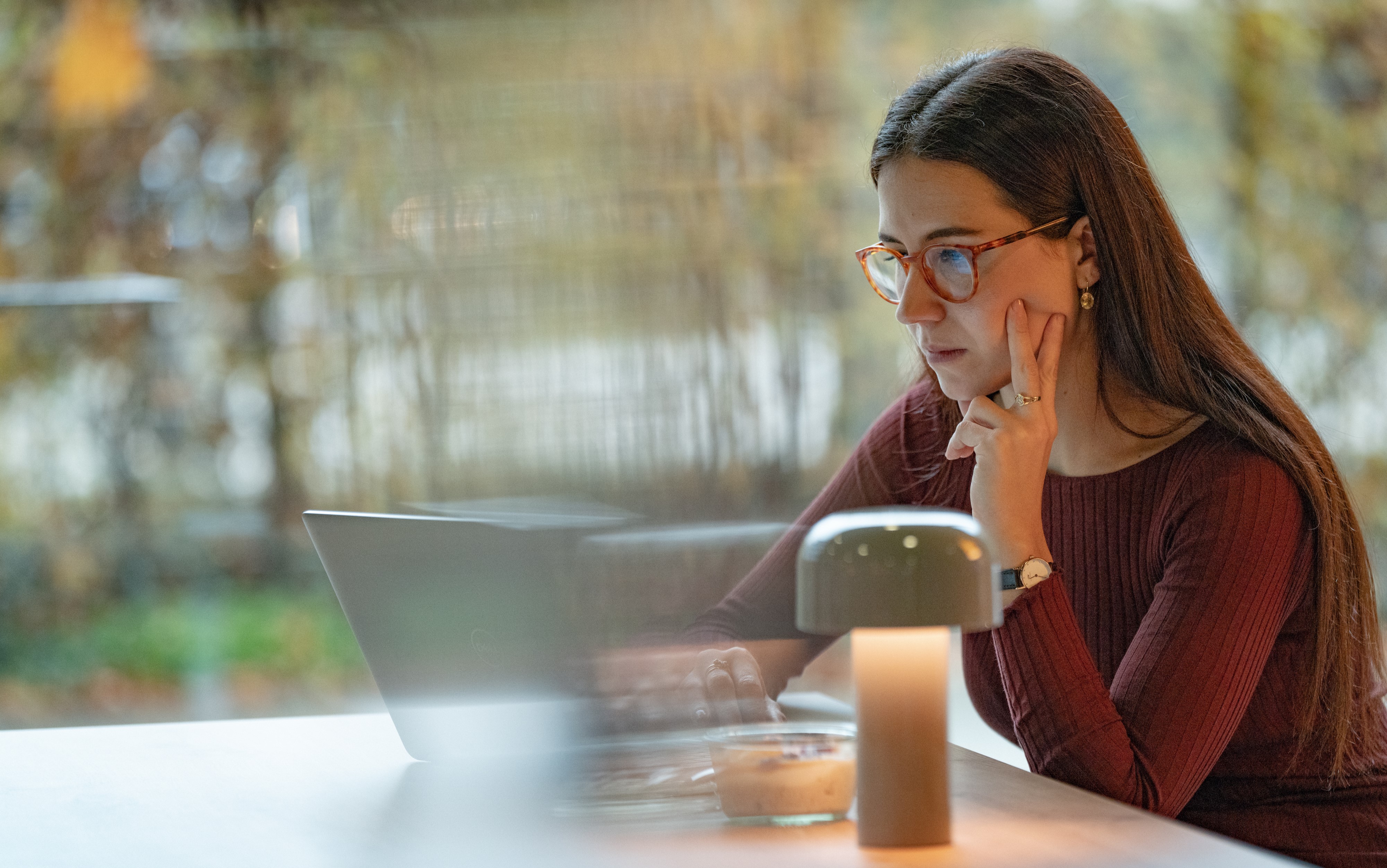 Young woman working in full focus on her laptop.