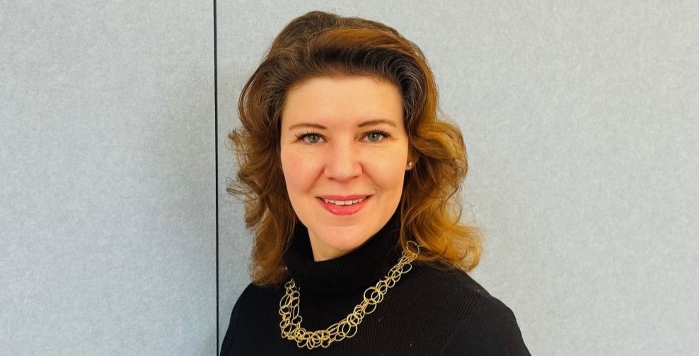 Young woman smiling into the camera.