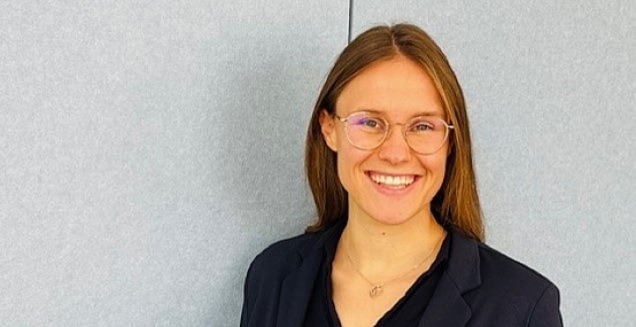 Young woman smiling into the camera.
