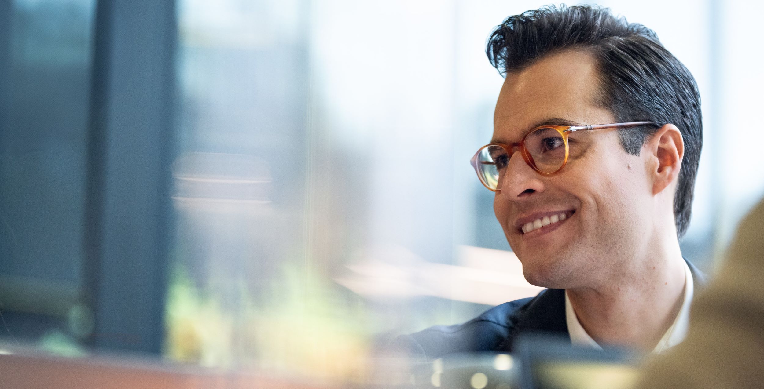 Smiling young man, not looking into the camera.
