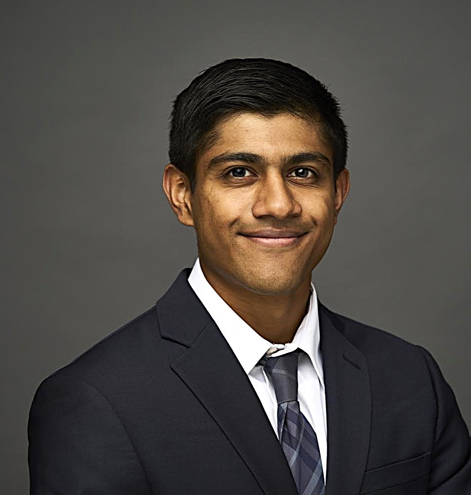 Portrait of a young man smiling into the camera.