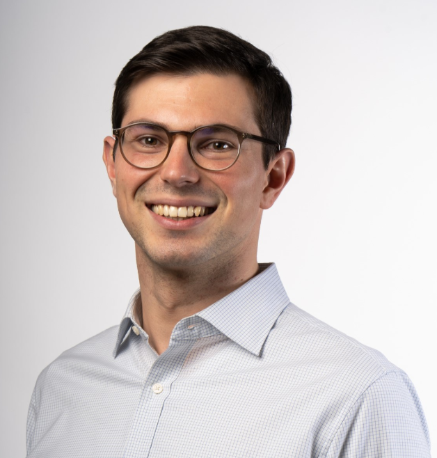 Smiling man with glasses in dress shirt, portrait
