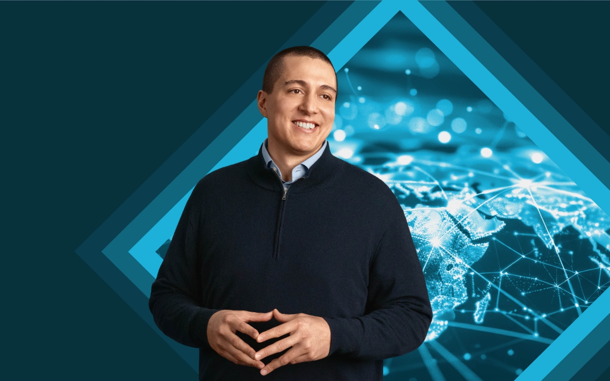Smiling man standing in front of digital world map.