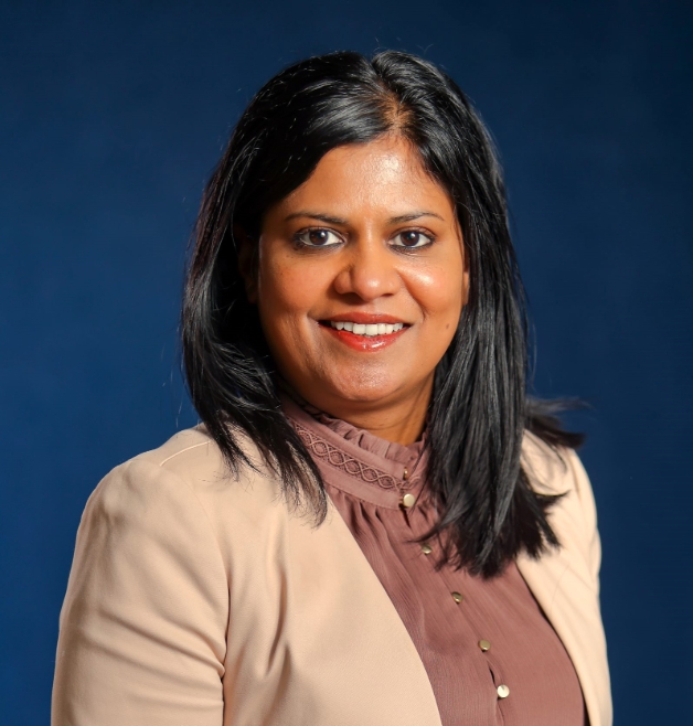 Smiling woman in formal outfit.