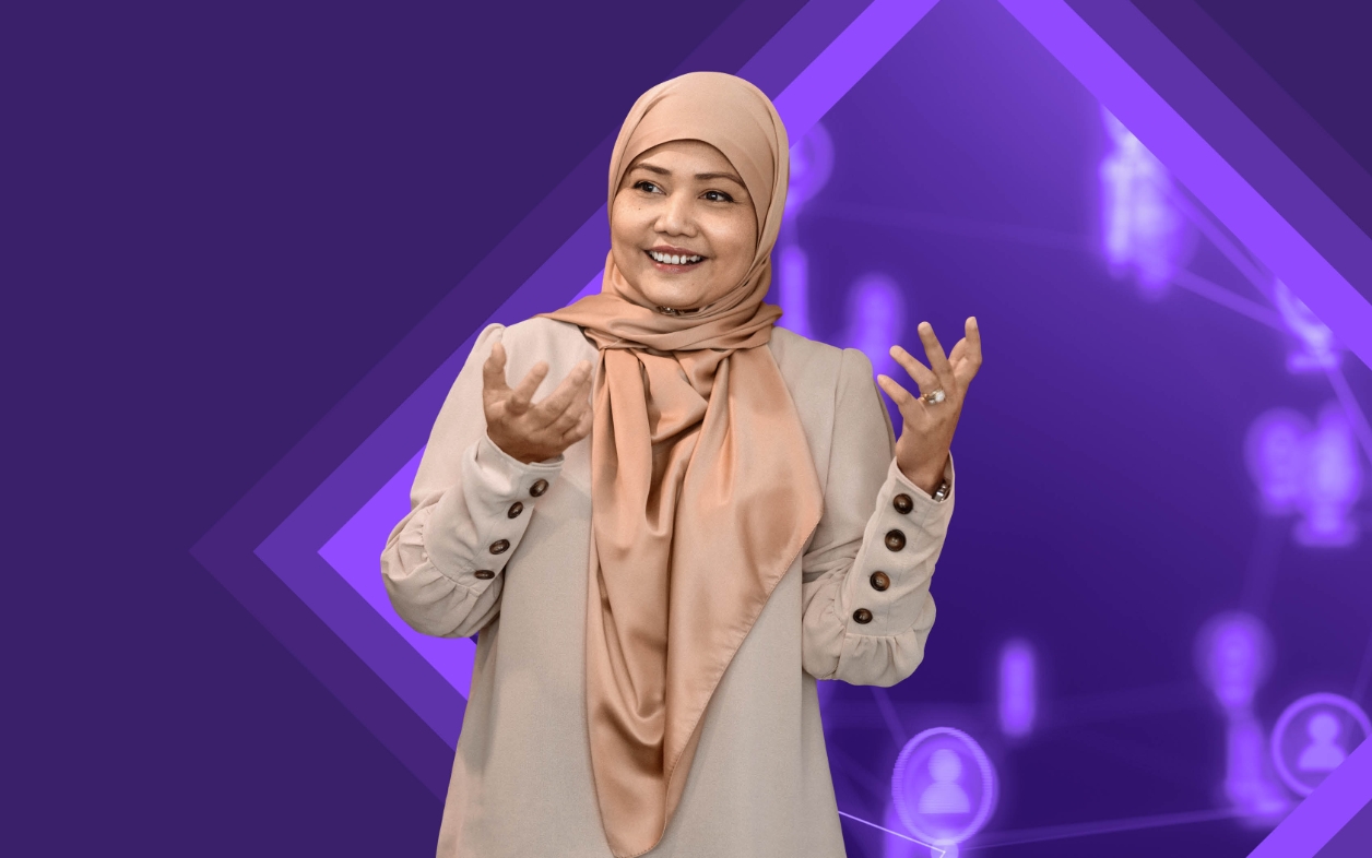 Smiling woman in hijab speaking with gestures.
