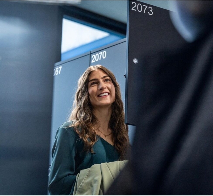 Woman by lockers smiling