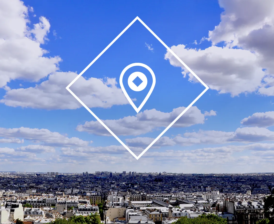 Panoramic photo of a city landscape with blue sky, with an illustration of a location pin