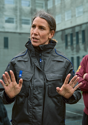 Begeleider spreekt buiten met kleine groep mensen