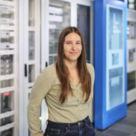 Smiling engineer in data center hallway scene now!