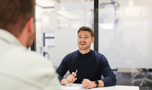 Smiling man talking in modern office