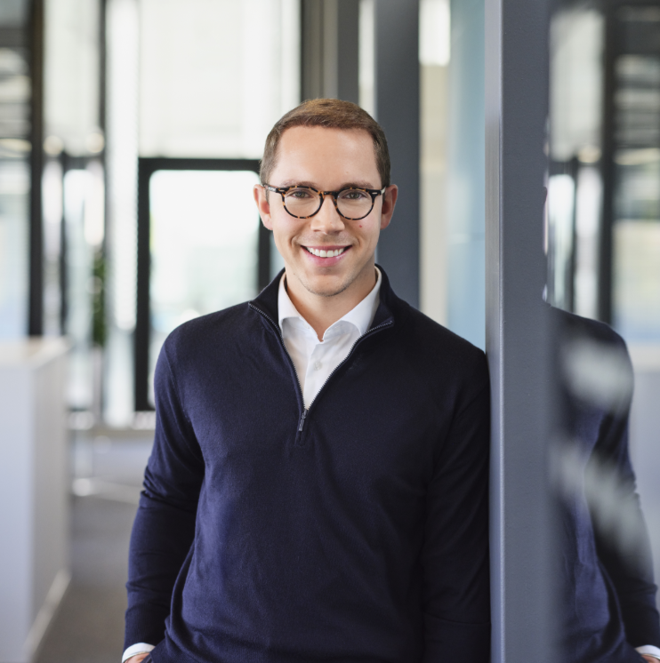 Smiling man with glasses in modern office