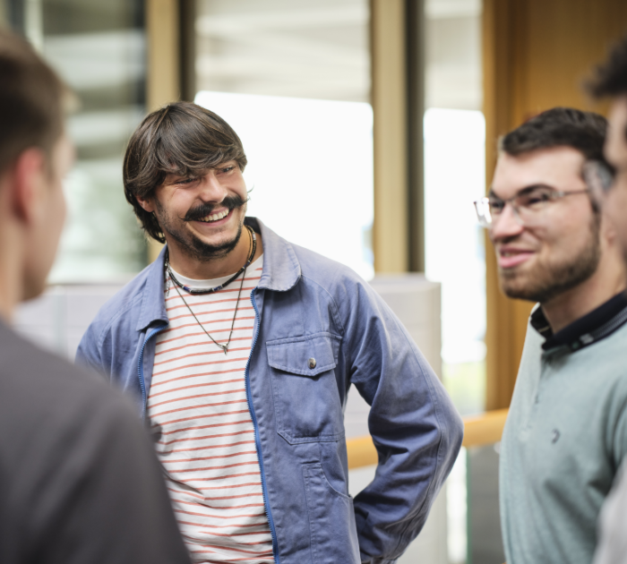 Employees having a discussion in an office setting.