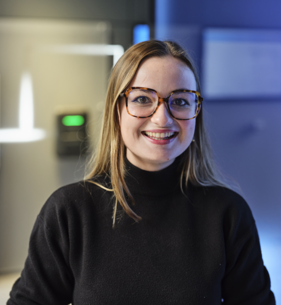 Person wearing a black sweater in an indoor setting.