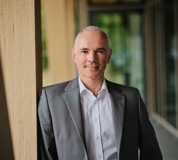 Smiling man in a professional portrait with short hair