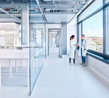 Two people discussing in a modern laboratory
