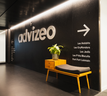 Advizeo office hallway with sign, bench, and plant