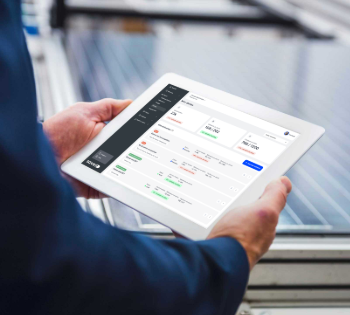 Hands holding tablet with performance dashboard outdoors